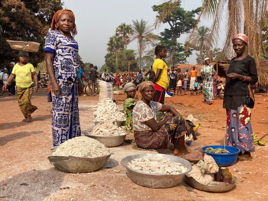 A group of women selling manioc in a market in DRC.